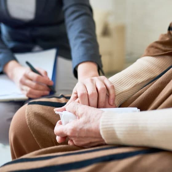 A Woman Holding Hands Of An Elderly In Session— Plume Consulting Hypnotherapist in Penrith